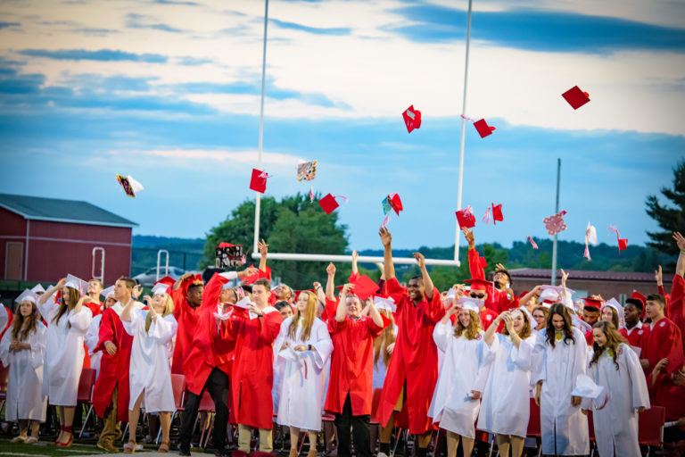 Seniors throwing their caps after graduating