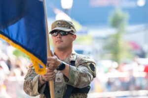 A military member waving a flag