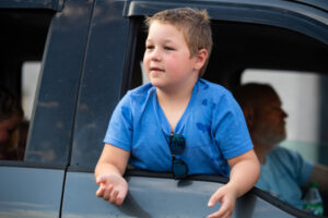 A boy waving to the crowd