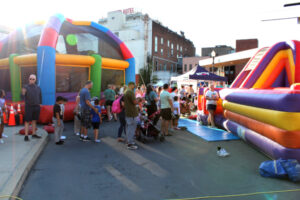 Kids lined up outside a bouncy castle